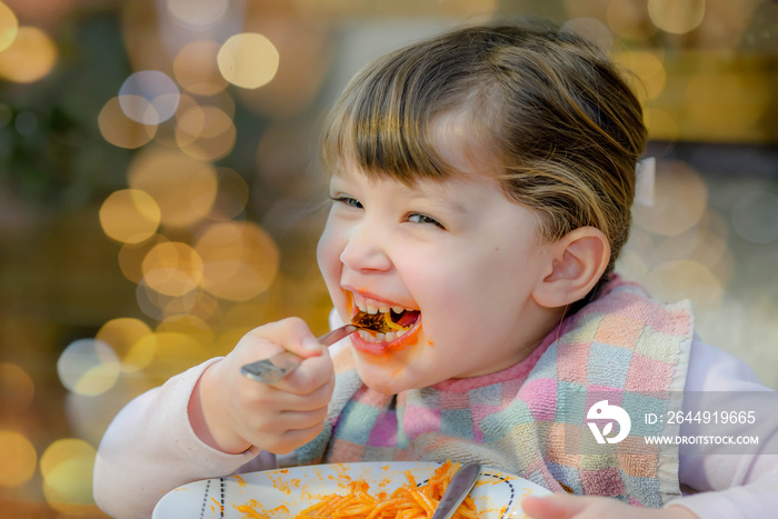 cute little girl eating spaghetti bolognese