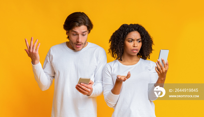 Disappointed interracial couple with smartphones suffering problems with wifi connection