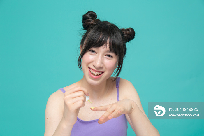 Studio portrait of smiling girl painting nails