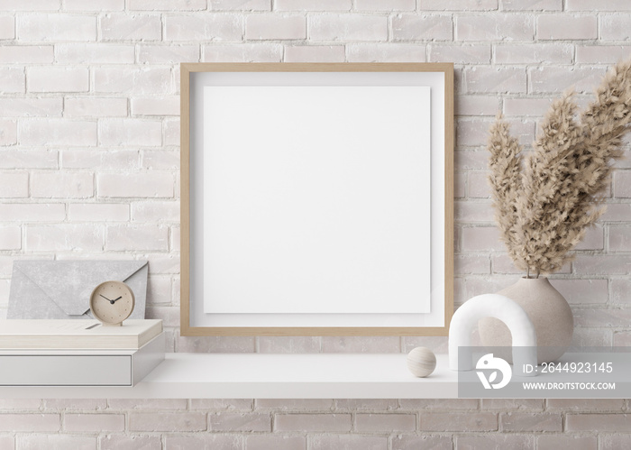 Empty square picture frame on white brick wall in modern room. Mock up interior in contemporary style. Free, copy space for picture. Pampas grass in vase, books, sculpture. 3D rendering.