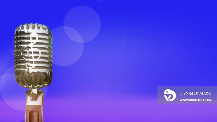 Retro microphone for recording and performing for singers on stage. Bokeh light background can put advertising text.