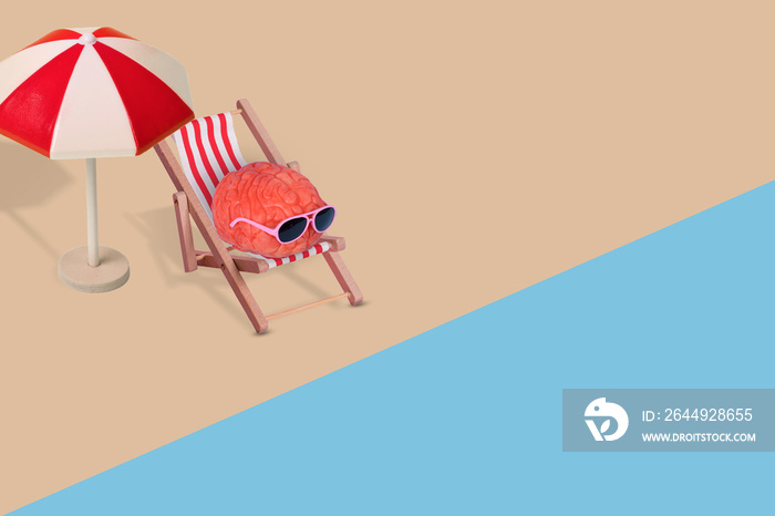 Creative funny composition made of human brain with sunglasses, relaxing on the beach.