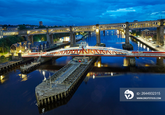 Elevated view of the ’Bridge Street’ swing bridge at the Newcastle upon Tyne quayside illuminated at dusk