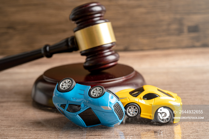 Hammer gavel judge with car vehicle accident, insurance coverage claim lawsuit court case.