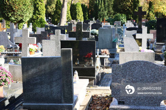 Widok na cmentarz z nagrobkami w czasie święta zmarłych.