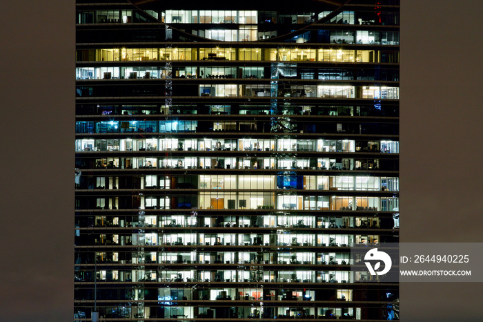 Symmetrical windows in an office building at night