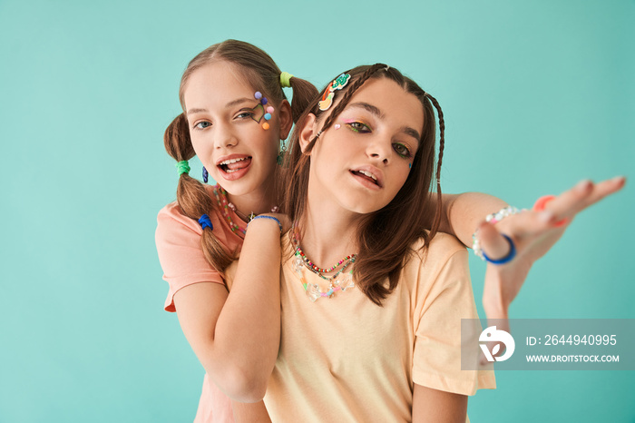 Teenagers embracing each other and having fun while posing at the studio