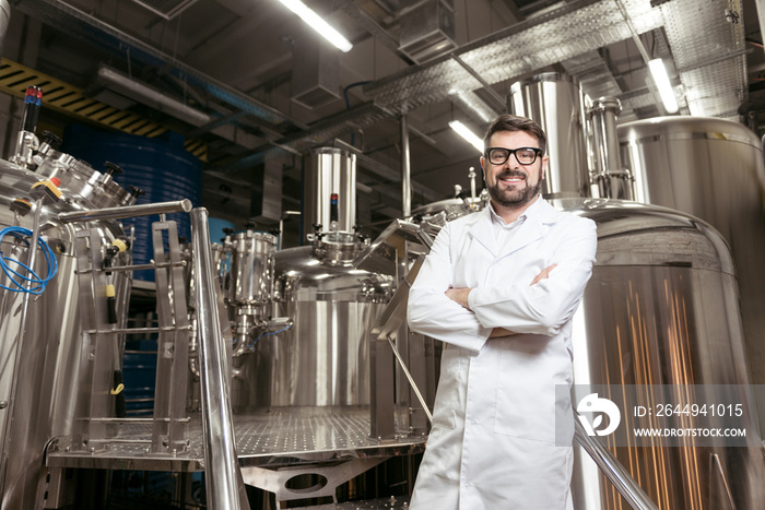 Joyful man posing with brewing mechanisms