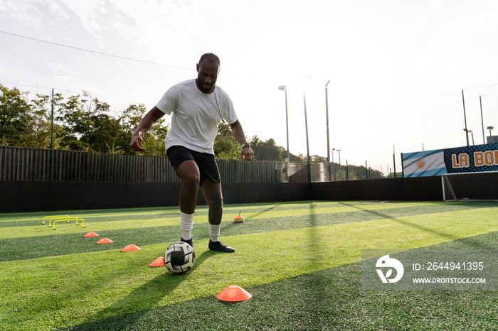 Soccer player practicing on soccer field