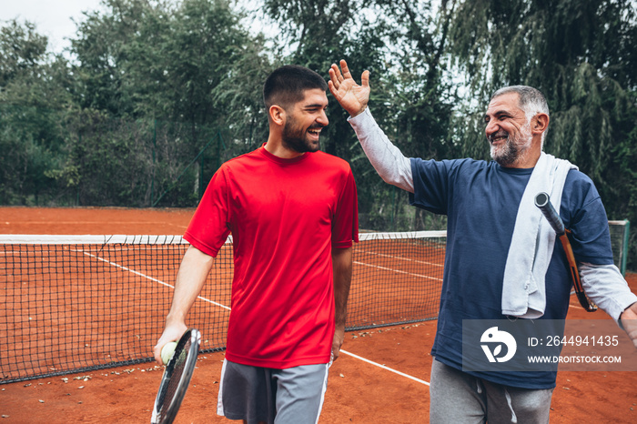 friends playing tennis outdoor on clay court