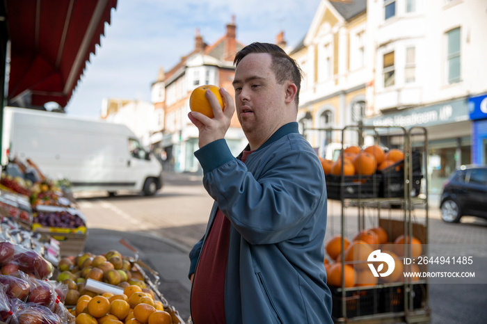 Man examining fruit in grocery store