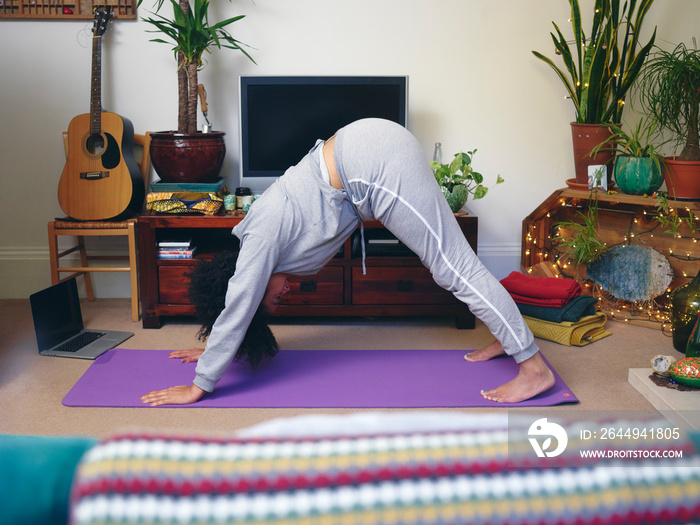 Woman practicing yoga at home