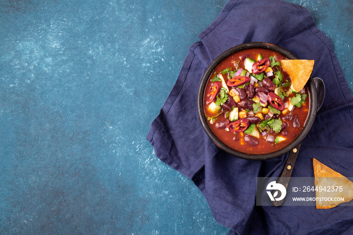 Mexican chile bean soup on blue background