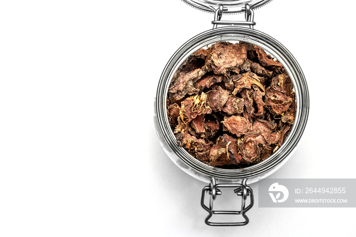 cut dry root of Rhodiola rosea in a glass jar on natural white background