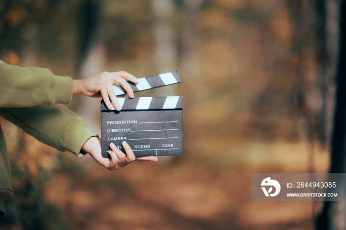 Director Holding a Cinema Slate in Outdoors Set Independent filmmaker using natural light and resources to produce videos