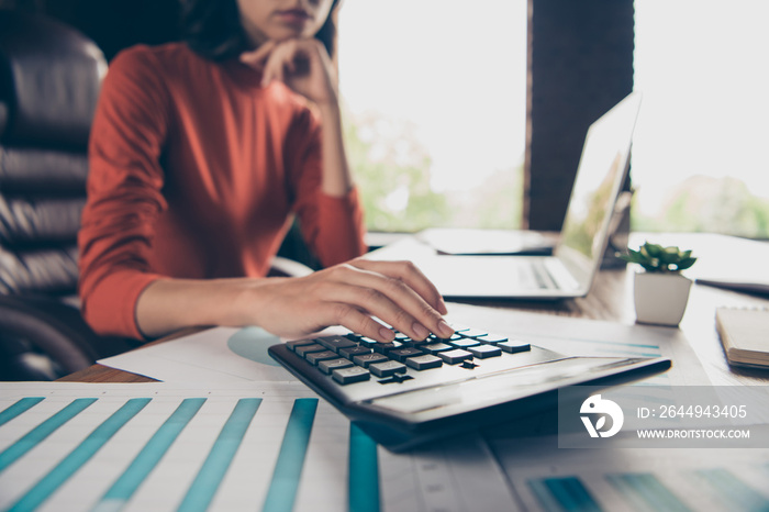 Cropped view photo of charming nice lady chief boss count trade calculate profit table desk think thoughtful ponder touch chin hand fingers wear style stylish trendy red pullover interior