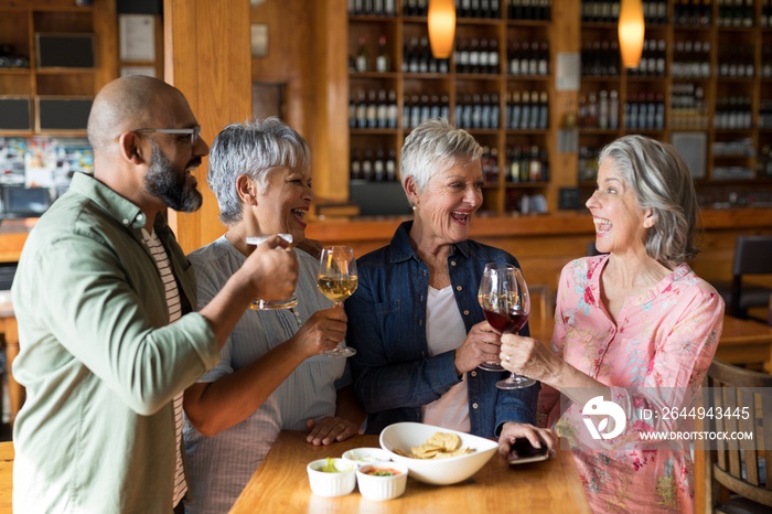 Happy friends having drinks in bar