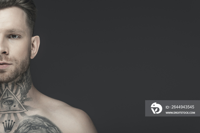 cropped view of young shirtless tattooed man, isolated on grey