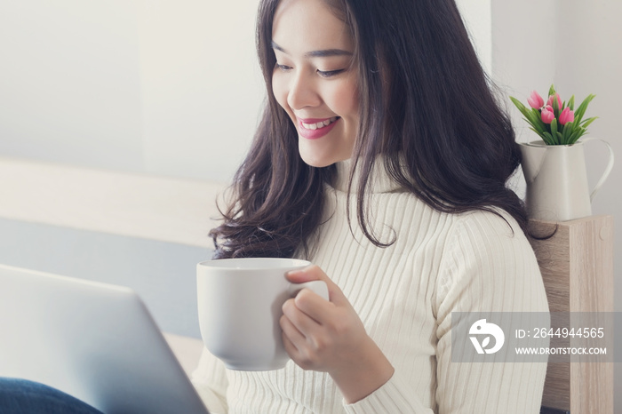 Young beauty Asian woman using computer at home.