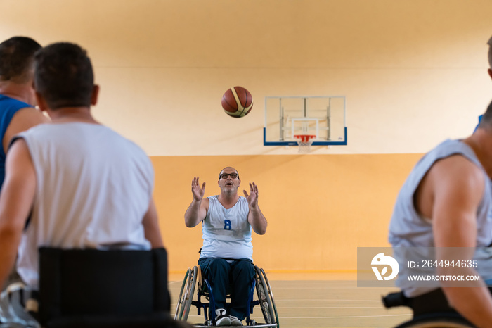 disabled war veterans in action while playing basketball on a basketball court with professional sports equipment for the disabled