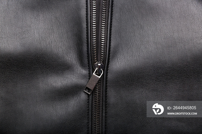 opened zip on black leather surface