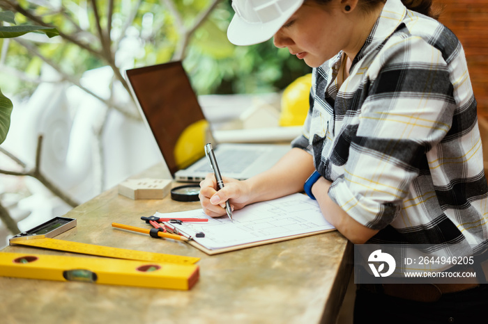 Engineering and architecture concept,engineers working on a building site holding a blueprints,architect   working  with engineer women inspection in workplace for architectural plan