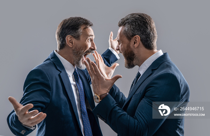 photo of businessmen arguing with aggression. two arguing businessmen isolated on grey