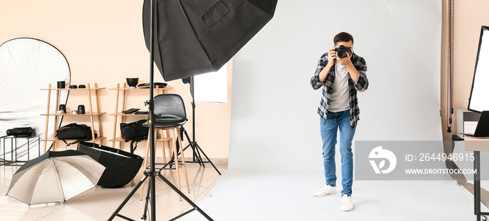 Professional male photographer working in studio