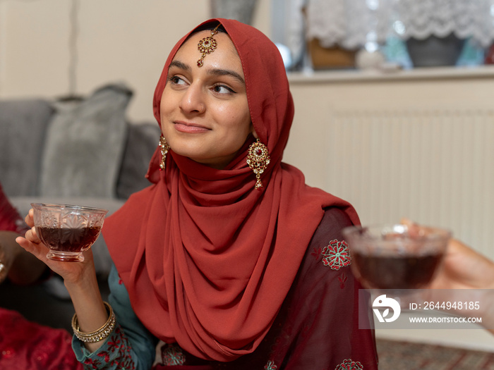 Woman holding teacup and looking away