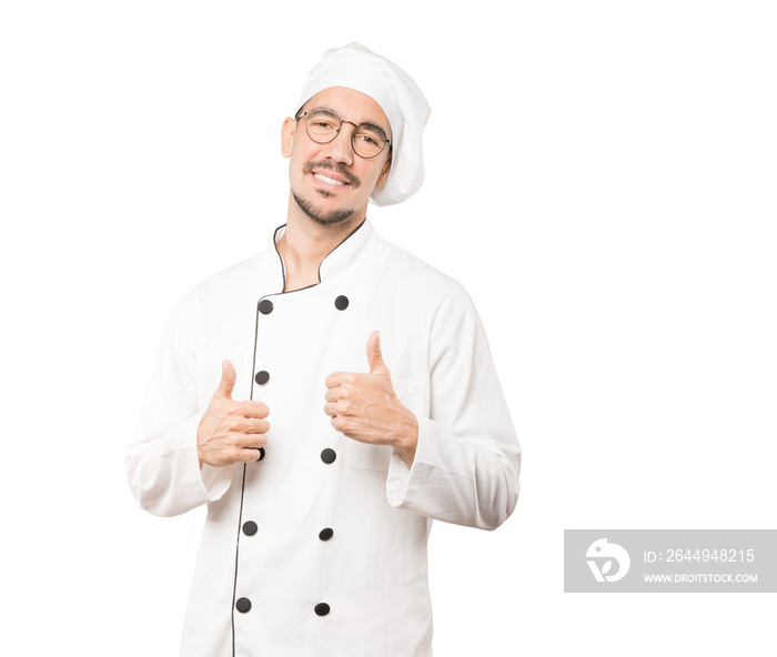 Happy young chef gesturing that everything is fine