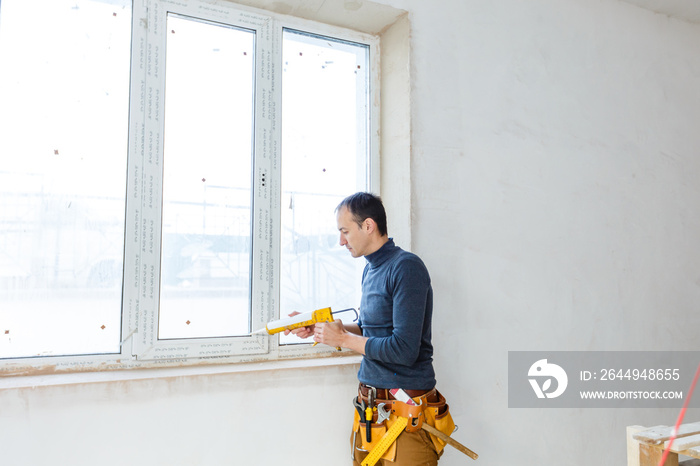 Worker in glazier’s workshop, warehouse or storage handling glass