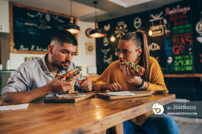 couple having fun eating in food corner bar