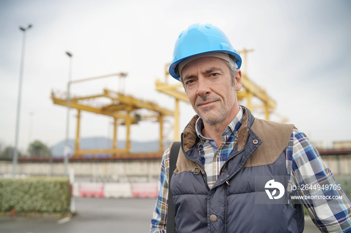 Construction worker on industrial sight looking at camera