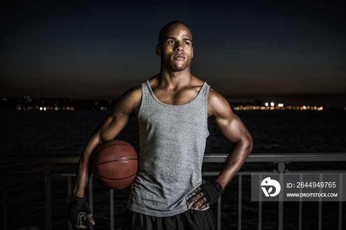 Man with basketball at night