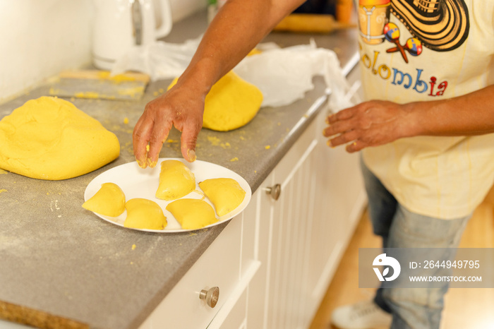 Midsection of man preparing empanadas