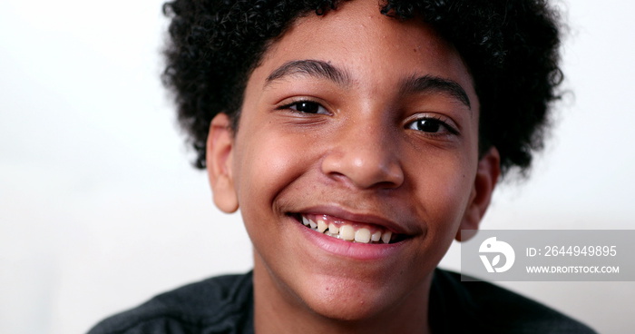 Mixed race young boy smiling at camera portrait. Ethnically diverse male kid