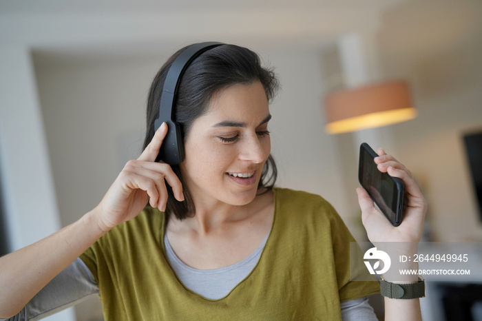 Woman listening to music with bluetooth headset