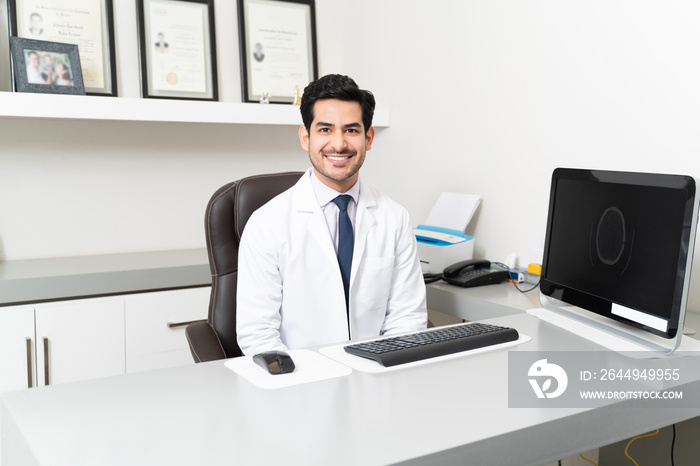 Smiling Male Doctor In Lab Coat At Clinic