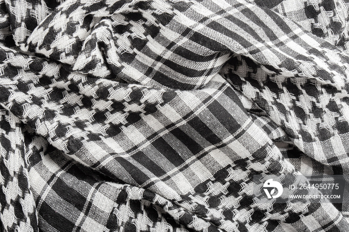 Traditional tissue black and white arabic man’s head scarf Shemagh (Keffiyeh). Saudi men s national headdress called Ghutrah. Close up textile background.