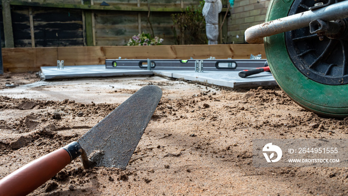 Trowel laying on the ground ready to lay a patio