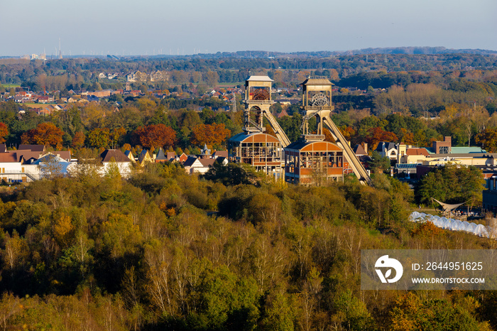 Two former coal mine elevators rising up over the national park Hoge Kempen near the city of Maasmechelen. The mine area is converted into a tourist domain with hiking routes.