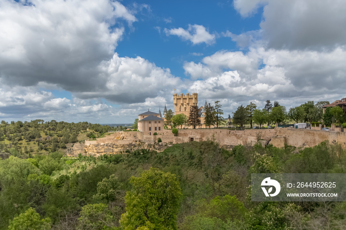 Majestic view at the iconic spanish medieval castle palace Alcázar of Segovia, towers and domes, fortress and surrounding vegetation