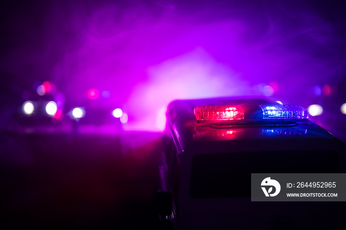 Police cars at night. Police car chasing a car at night with fog background. 911 Emergency response pSelective focus