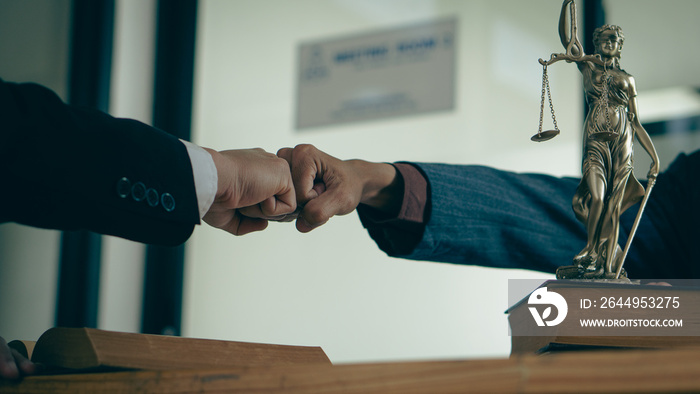 Lawyers shake hands with businessmen to make a deal. legal advisor Various contract consulting services to plan court proceedings with scales and hammers placed beside