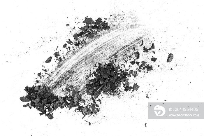 Black dust powder of charcoal on a white background, top view. Charcoal dust with fragments.