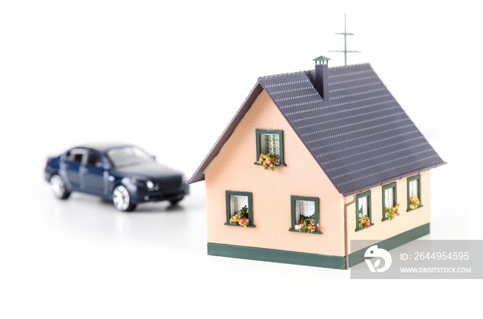 House miniature and car model in background