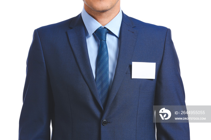 Elegant man in suit with blank badge on white background