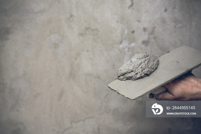 Plasterer renovating indoor walls.