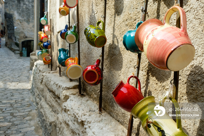 Multicolored ceramic jugs. Street trade. Les Baux-de-Provence is ten of the most beautiful villages of Provence. Copy space.