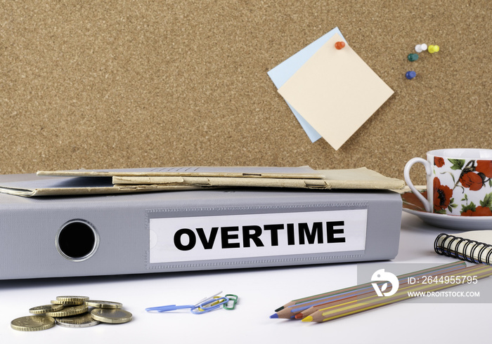 Overtime - folder on white office desk.